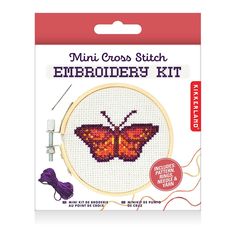 a cross stitch kit with an orange butterfly on the front and purple thread in the back