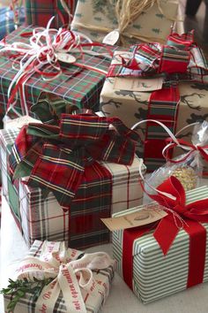 many wrapped presents are stacked on top of each other