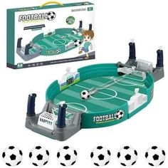 a toy soccer game set in front of some balls