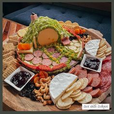 a platter filled with meats, cheese and crackers