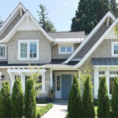 a house with white trim and gray roof