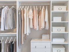 an organized closet with clothes and boxes