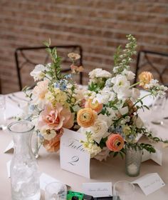 a table with flowers and place cards on it