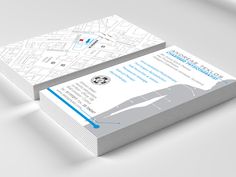 two business cards on top of each other with a map in the middle and blue lines at the bottom