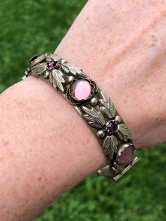 "Vintage circa 1940s made in Italy alpaca bracelet. Alpaca is a silver substitute with no silver content. The bracelet is set with lovely purple cabochons and has a raised foliate design. The clasp is a pin clasp in good working order. The inside diameter of the bracelet is 2 3/8\". I think this will fit a medium wrist around 7\". It is a bit big on my 6\" wrist but still comfortable if you like a loose style bracelet." Big Bracelets, Cameo Bracelet, Snake Bracelet, Silverware Jewelry, Hinged Bracelet, Purple Glass, Jewelry Inspo, Quality Jewelry, Piercing Jewelry