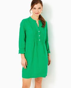 Easy fit, tunic shirtdress with a stand collar, half placket with a front pintuck detail, side slits, and pockets. 36" from top of shoulder to hem (based on a size small/4). Skims the body. Roomier fit. Enjoy extra hem flexibility with this style. Wear as-is or let it out for some extra length.  Lagoon Linen™ (100% Linen). Machine wash cold, delicate cycle, separately, or dry clean. Imported. An easy and colorful daytime essential, the Rhoda Linen Dress is embellished with a stand collar and pintuck details, plus practical pockets. Fall Split Neck Tunic, Elegant Tunic With Buttons, Fall Daywear Dress With Split Neck, Workwear Shift Shirt Dress, Casual Dresses With Stand Collar For Workwear, Fall Dresses With Pintucks, Elegant Spring Tunic With Split Neck, Spring Workwear Tunic With Buttons, Elegant Shift Shirt Dress For Daywear