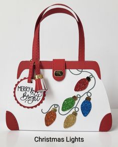 a handbag with christmas lights on it and merry and bright tag hanging from the handle