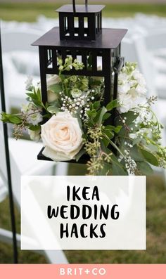 an image of a wedding card with flowers and a lantern on the grass in front of it