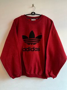 Beautiful red Adidas sweatshirt. Very good condition. The 90's Pit to pit 67 cm Oversized Red Sweatshirt With Graphic Print, Oversized Red Graphic Print Sweatshirt, 90s Style Winter Sweatshirt With Logo Print, 90s Winter Sweatshirt With Logo Print, Red Crew Neck Hoodie With Logo Print, Red Crew Neck Sweatshirt With Graphic Print, Red Graphic Print Sweatshirt For Streetwear, Red Logo Print Sweatshirt For Fall, Red Hoodie With Logo Print And Crew Neck