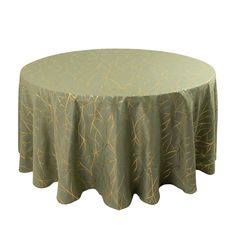 a round table covered with a green and gold patterned tablecloth on an isolated white background