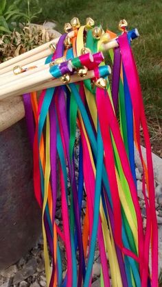 a bunch of colorful streamers hanging from a planter in front of a house