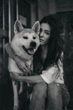 black and white photograph of a woman hugging her dog