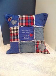 a blue pillow with patchwork on it that says i love you john and hearts