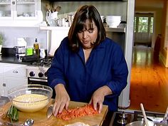 a woman is preparing food in the kitchen