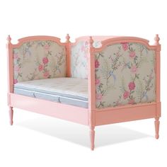 a pink bed frame with flowers on it