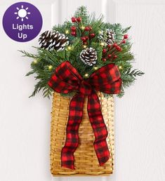 a basket filled with pine cones and greenery on top of a white door handle