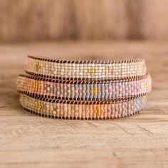 the multicolored beaded bracelets are stacked on top of each other