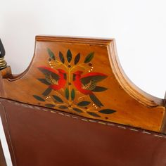 an old wooden bed frame with painted designs on it's headboard and foot board