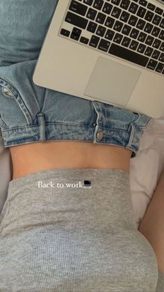 a person laying in bed with their laptop on their stomach and the words back to work written across them