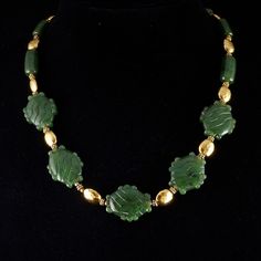 "Beautiful top quality nephrite jade \"stone\" glyph beads strung with golden vermeil beads (24k gold on sterling silver) with a hammered finish.  You will not find an item like this .. of this quality .. for this price .. anywhere! 20\" with vermeil s hook clasp ... this stunning necklace comes in a plush jaguar print drawstring bag. The Maya and Aztec considered green a sacred color, they attached special value to green things ... even small slivers of jade were polished and perforated for suspension, and large pieces were carved in the shape of human faces, animals, or... shaped like a hand. This item comes from my Maya and Aztec inspired line of unique jade jewelry: http://www.michaelgoard.com/jade.htm" Luxury Green Southwestern Beaded Necklaces, Mexican Necklace Green, Luxury Southwestern Green Jewelry, Aztec Gold Necklace, Aztec Stone, Human Faces, Jaguar Print, Green Things, S Hook