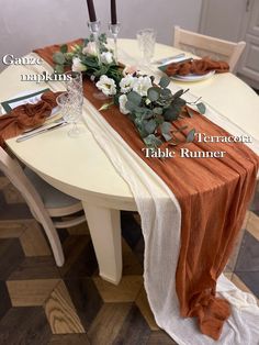 the table runner is set with flowers on it