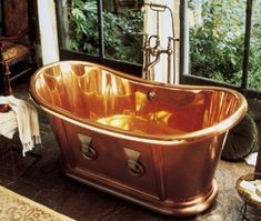 an old fashioned copper bath tub in a bathroom