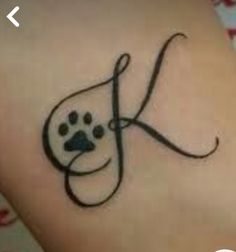 a dog paw tattoo with the letter k on it