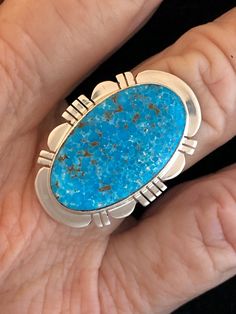 "This Turquoise gemstone is intriguing with its matrix. The Turquoise is Kingman Turquoise and has a deep blue Turquoise. Kingman Turquoise is found just off the highway about 20 miles Northwest of Kingman, Arizona. This is the highway to Las Vegas, Nevada. The ring is stamped, Sterling Silver and Paul Sanchez the artist Hallmark. Paul is a well-known silversmith and lives in the Albuquerque, New Mexico area. The ring weighs 10.22 grams and the ring measures 1 1/8\" X 7/8\" in size. This stunnin Collectible Untreated Blue Turquoise Ring, Collectible Blue Turquoise Inlay Ring, Southwestern Style Untreated Blue Turquoise Ring, Southwestern Turquoise Chrysocolla Ring, Southwestern Chrysocolla Turquoise Ring, Southwestern Blue Chrysocolla Rings, Southwestern Blue Jewelry With Large Stone, Southwestern Style Blue Jewelry With Large Stone, Southwestern Blue Large Stone Jewelry