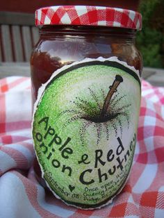 an apple jam is sitting on a checkered tablecloth