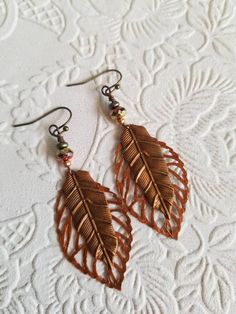 "These handpainted leaves are so romantic and a perfect pair for dressing up or every day!! You can choose the long earwires or the shorter ones!! *The long earwires measure 1.5\" with a 2 1/4\" dangle. *The shorter earwires are 1/4\" long with a 2 1/4\" dangle. The brass earwires are nickel and lead free.  All of my handmade treasures come in a craft brown box tied with raffia.  Colors may vary from the pictures to the actual pieces.  Thank you for stopping by!" Garden Cottagecore, Oak Leaf Earrings, Woodland Earrings, Crystal Heart Earrings, Crescent Earrings, Copper Leaf, Unusual Earrings, Fancy Earrings, Brown Box