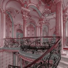 an ornate staircase in a pink and white building