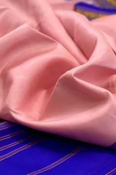 Fabric : Pure Kanjivaram Silk Type : Thread work korvai contrast Body Color : Light lotus pink Border Color : Bluish purple Blouse Color: Bluish purple Pallu Color: Bluish purple Approximate height - 46 - 52" Approximate weight - 1.4 lbs Approximate Length - 6.25 - 6.50 mtrs (inclusive of blouse length) Technique on the blouse : Aari and mirror work Saree comes with fall, picot and tassels done when applicable. Blouse piece is cut. Kindly Note : The colors you see on your device may vary due to Pink Formal Blouse With Traditional Drape, Elegant Pink Cotton Silk Traditional Wear, Pink Raw Silk Dupatta For Formal Occasions, Pink Silk Traditional Wear For Formal Occasions, Formal Pink Raw Silk Dupatta, Formal Pink Silk Dupatta, Formal Pink Silk Traditional Wear, Elegant Pink Cotton Silk Saree, Unstitched Pink Traditional Wear In Cotton Silk