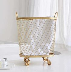 a white and gold basket sitting on top of a table