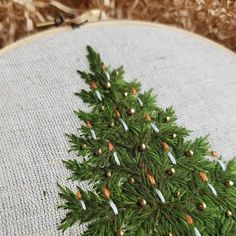 a close up of a cross stitch christmas tree