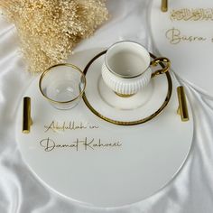 a white plate topped with a cup and saucer