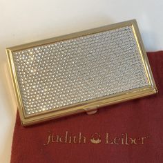 Engraved With Judith Leiber Signature. Gold Plated And Clear Crystals. A Stunning Work Of Art And Elegant Design. Exceptional Quality And Craftsmanship. Includes Judith Leiber Pouch And Iconic Snakeskin Box. Card Holder. New With Tags. Only Taken Out Of Packaging For Photos. No Scratches. Elegant Silver Card Holder With Card Slots, Elegant Silver Rectangular Card Holder, Elegant Compact Card Holder For Gift, Elegant White Rectangular Card Holder, Elegant Silver Card Holder For Formal Occasions, Gold Rectangular Card Holder For Formal Use, Elegant Gold Card Holder As Gift, Elegant Gold Card Holder For Gift, Gold Rectangular Formal Card Holder