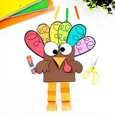 a paper turkey cut out with scissors and markers