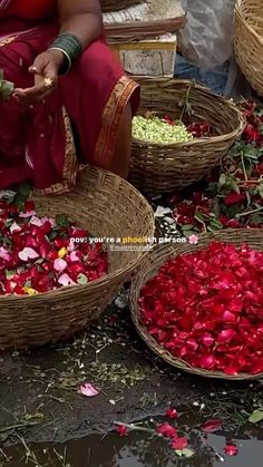 baskets filled with flowers sitting on top of a wet ground next to other baskets full of petals