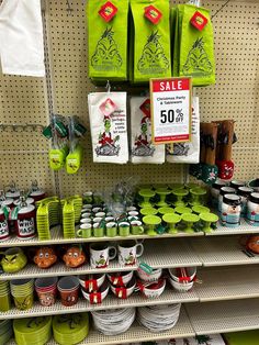 the shelves are filled with green and white christmas mugs, cups, and saucers