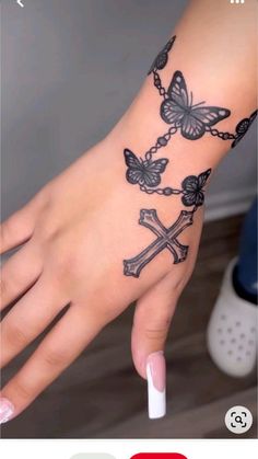 Cute Girly Tattoos On Hand, Skull And Flower Hand Tattoo, Sweet 16 Tattoo Ideas, Tattoo Ideas Loved Ones, Butterfly Rosary Tattoo, Cute Tattoos Hand, The Jamal Tattoo, Cross Chain Tattoo, Girly Arm Tattoos