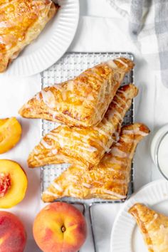 several pieces of pie sitting on plates next to peaches