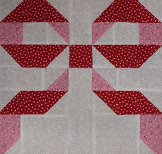 a red and white quilted wall hanging