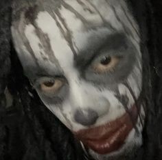 a close up of a person with makeup on their face and hair in the shape of a clown