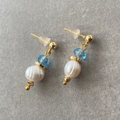 "Dainty Freshwater Pearl earrings are made of pearl, blue check crystal beads and gold. Combined with blue beads and gold, these sparkling pearl earrings are a perfect match for both your daily outfits and special occasions. Pearls have long been a source of pure fascination. Silky and glistening with many shades, these precious gems seem to carry a one-of-a-kind energy.Along with bringing your hormones into balance and ensuring your body is finding that sweet spot between ride and rest, pearls love to lend a hand when it comes to soothing our emotions. Known as a stone of inner wisdom, pearls help us to find the confidence we need to be our own advocates in the world. ☆ Each of the stones we use to create earrings were formed by nature over years. Each one is unique and beautiful just lik Blue Drop Pearl Earrings With Pearl Charm, Blue Pearl Charm Drop Earrings, Blue Pearl Charm Earrings As Gift, Blue Pearl Earrings With Pearl Charm, Blue Pearl Dangle Earrings, Elegant Light Blue Beaded Earrings As Gift, Handmade Stud Earrings, Pearl Love, Blue Crystal Earrings