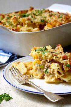 a casserole dish on a plate with a fork next to the casserole