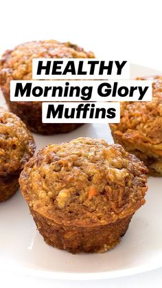 four carrot muffins on a white plate