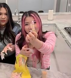 two women sitting at a table eating food