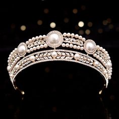 Feel like a princess as you walk down the aisle! Romantic and delicate, this royal tiara design can complete the most sophisticated of bridal looks. Glowing pearls and intricately faceted crystals work their way across the band in a swirly pattern and capture the light from every angle with a perfectly translucent appeal. Cast in lightweight alloy and gold/silver plated for a flawless finish, the tiara measures 1.8" at the tallest point (approx. 4.5cm) and 6" in diameter (approx. 15cm). Two smal Bridal Crown Crystal, Crystal Wedding Tiaras, Bridal Tiaras, Wedding Hair Headband, Crystal Bridal Tiaras, Pearl Tiara, Bride Tiara, Gold Tiara, Crystal Tiaras