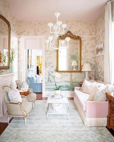 a living room filled with furniture and a chandelier