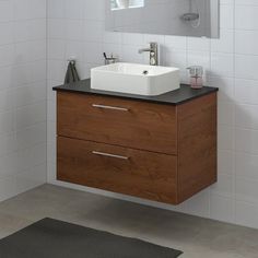 a bathroom with a sink, mirror and rug